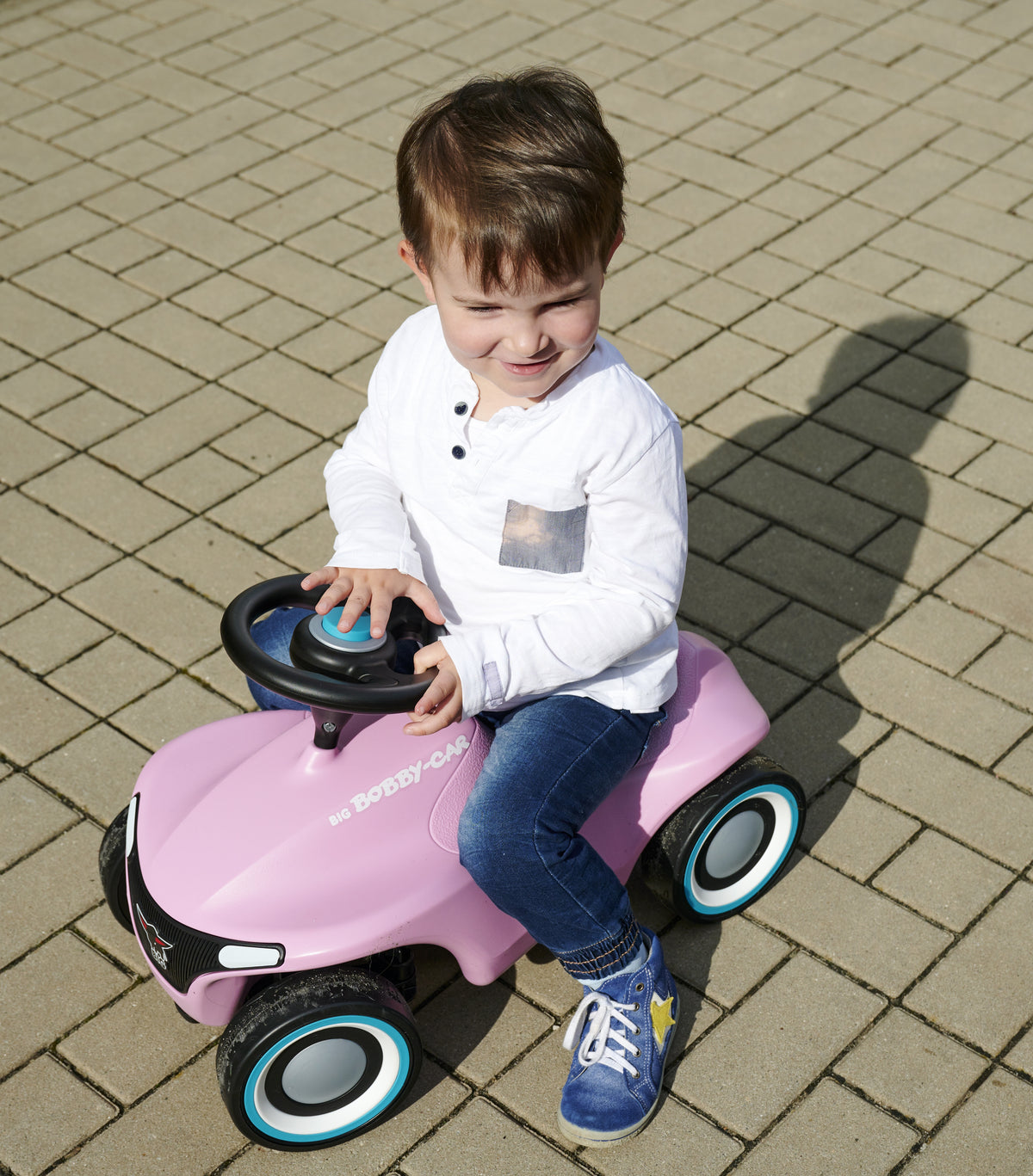 BIG Bobby Car Neo pink – toddler riding the pink Bobby Car