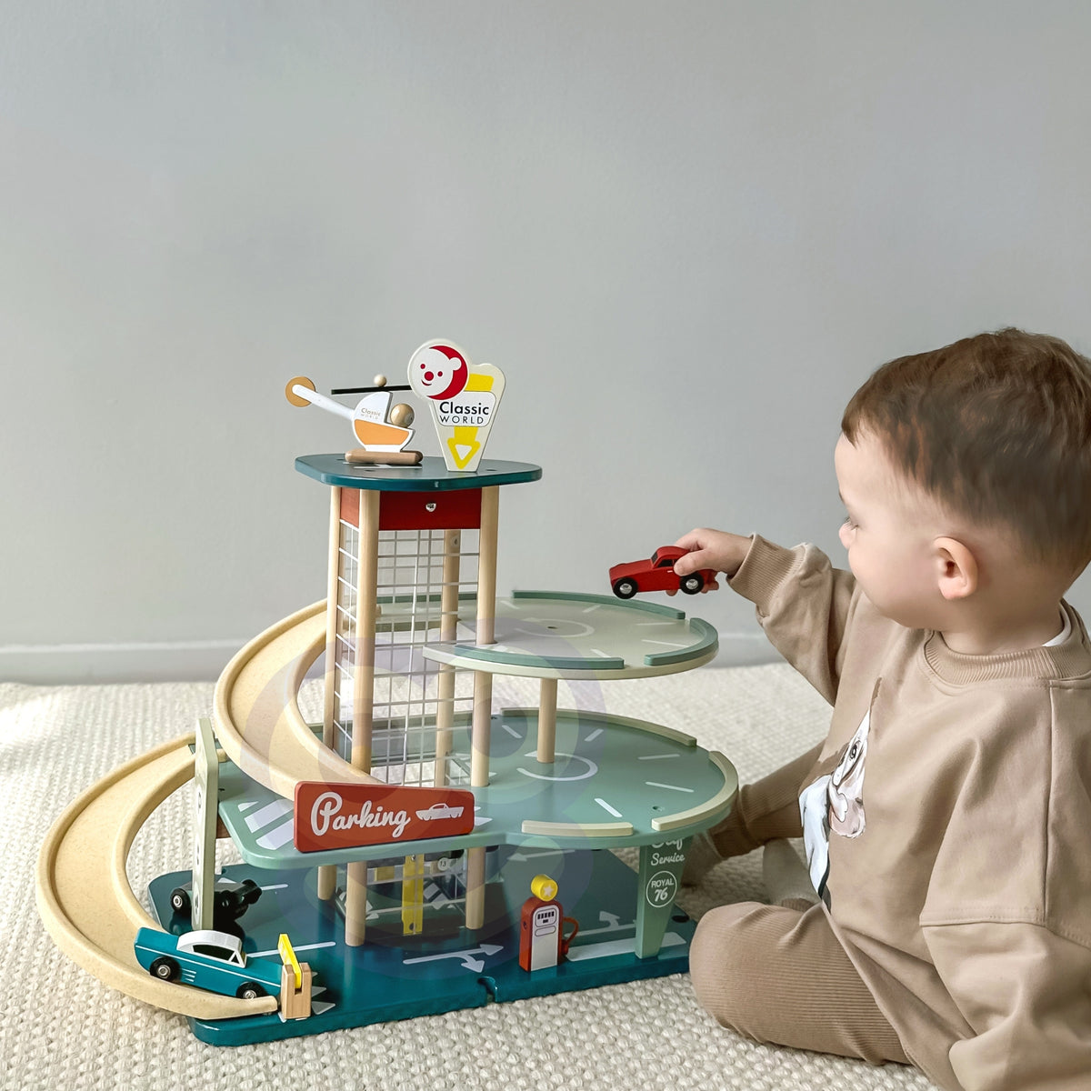 Child playing with cars in the retro garage