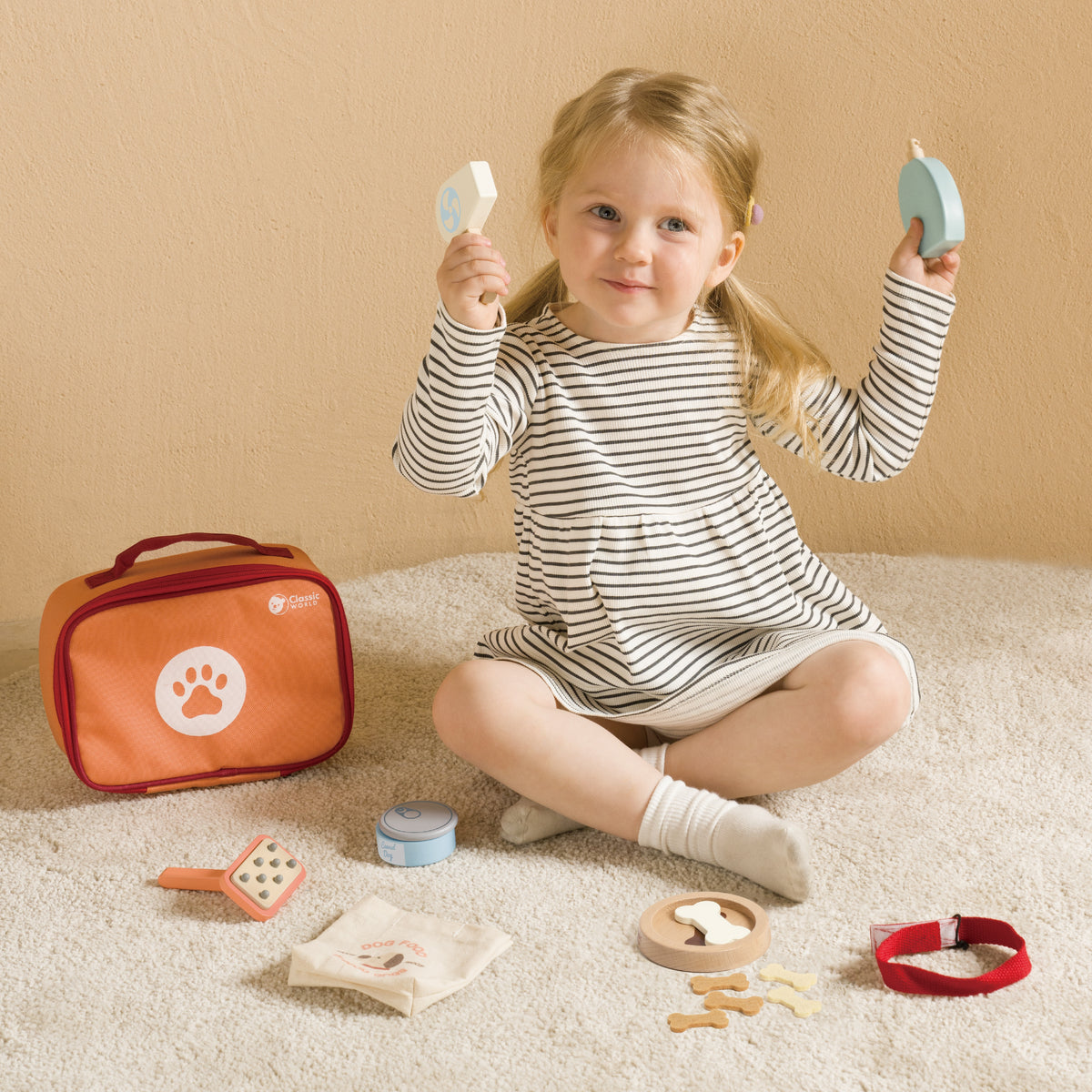 Child grooming a soft toy dog with the play set