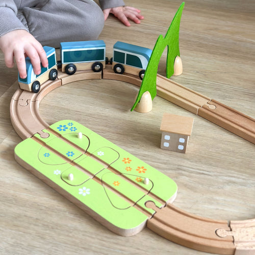 Wooden train with wagons carrying shape pieces