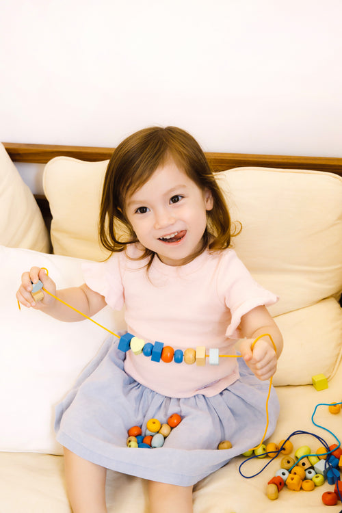 Colourful wooden beads and blocks in different shapes