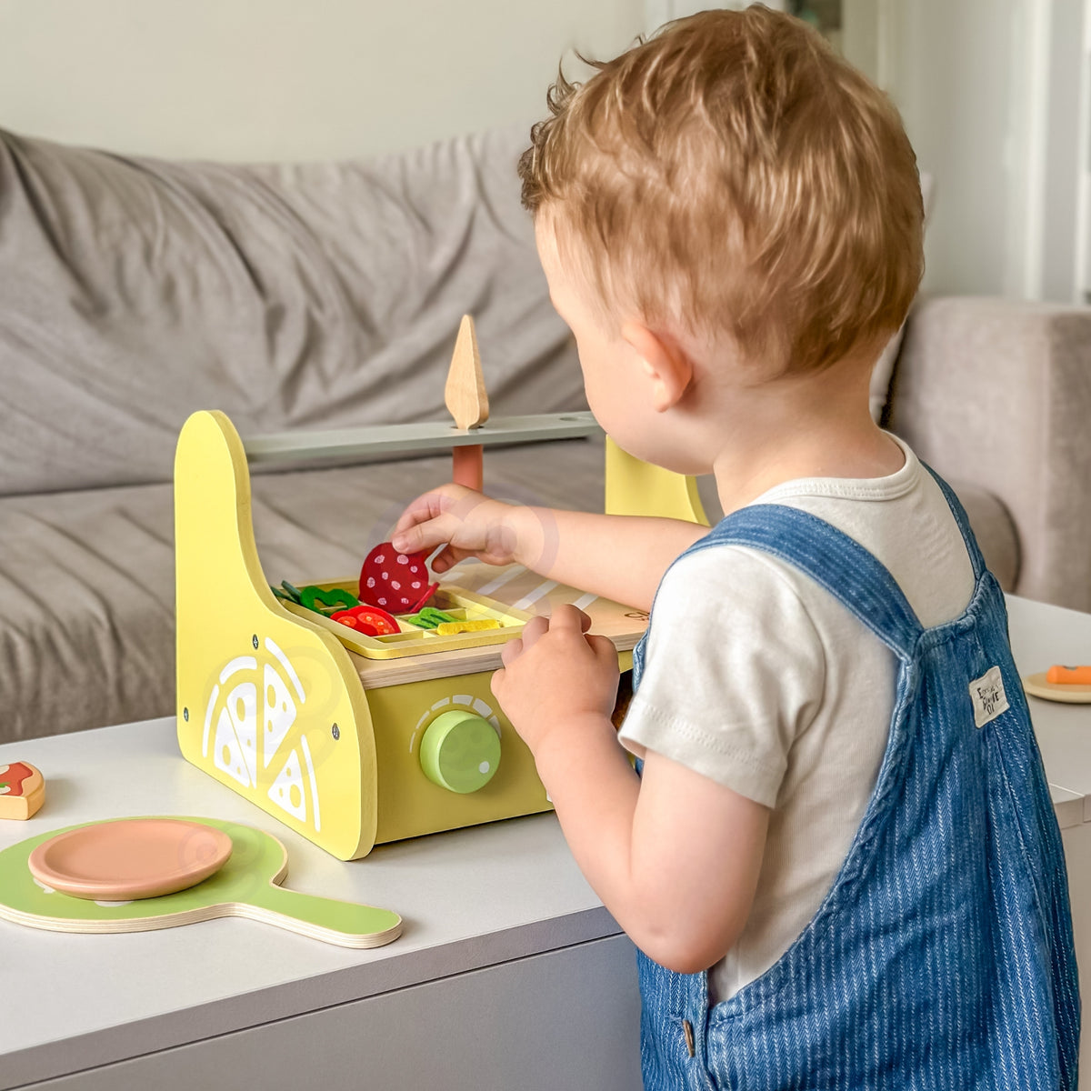 Classic World wooden pizza oven – child decorating a pizza