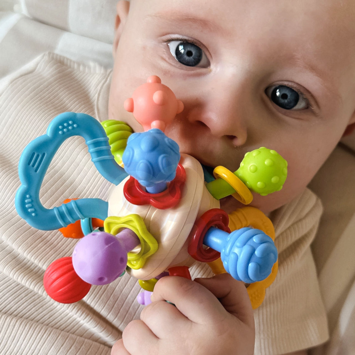 Ball rattle and teether with beads rattling inside