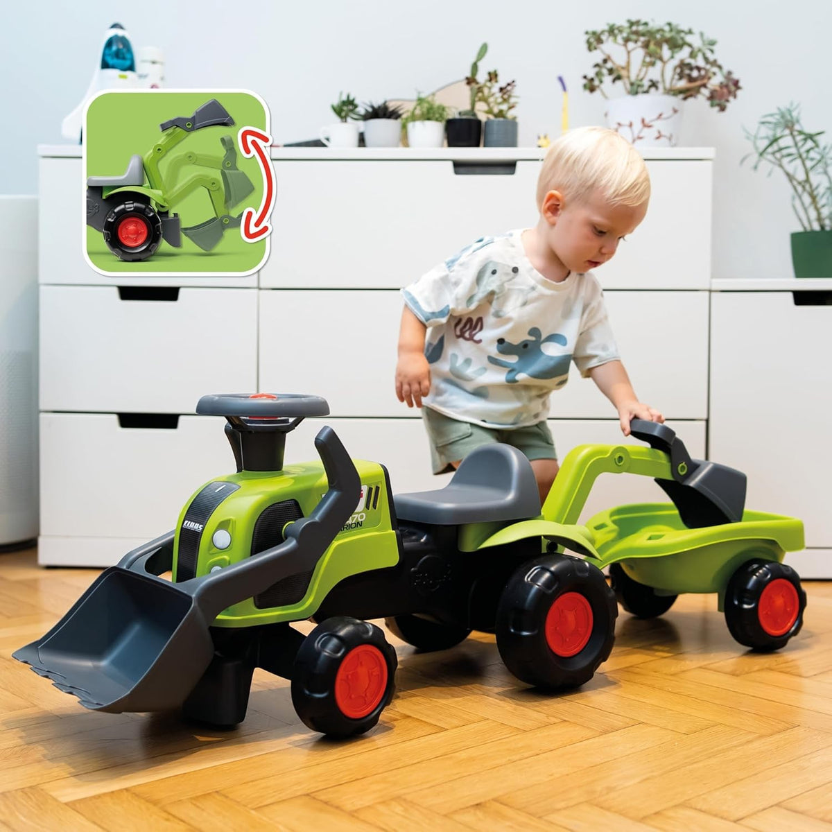 Zaļš Claas traktors ar kausu un ekskavatora roku