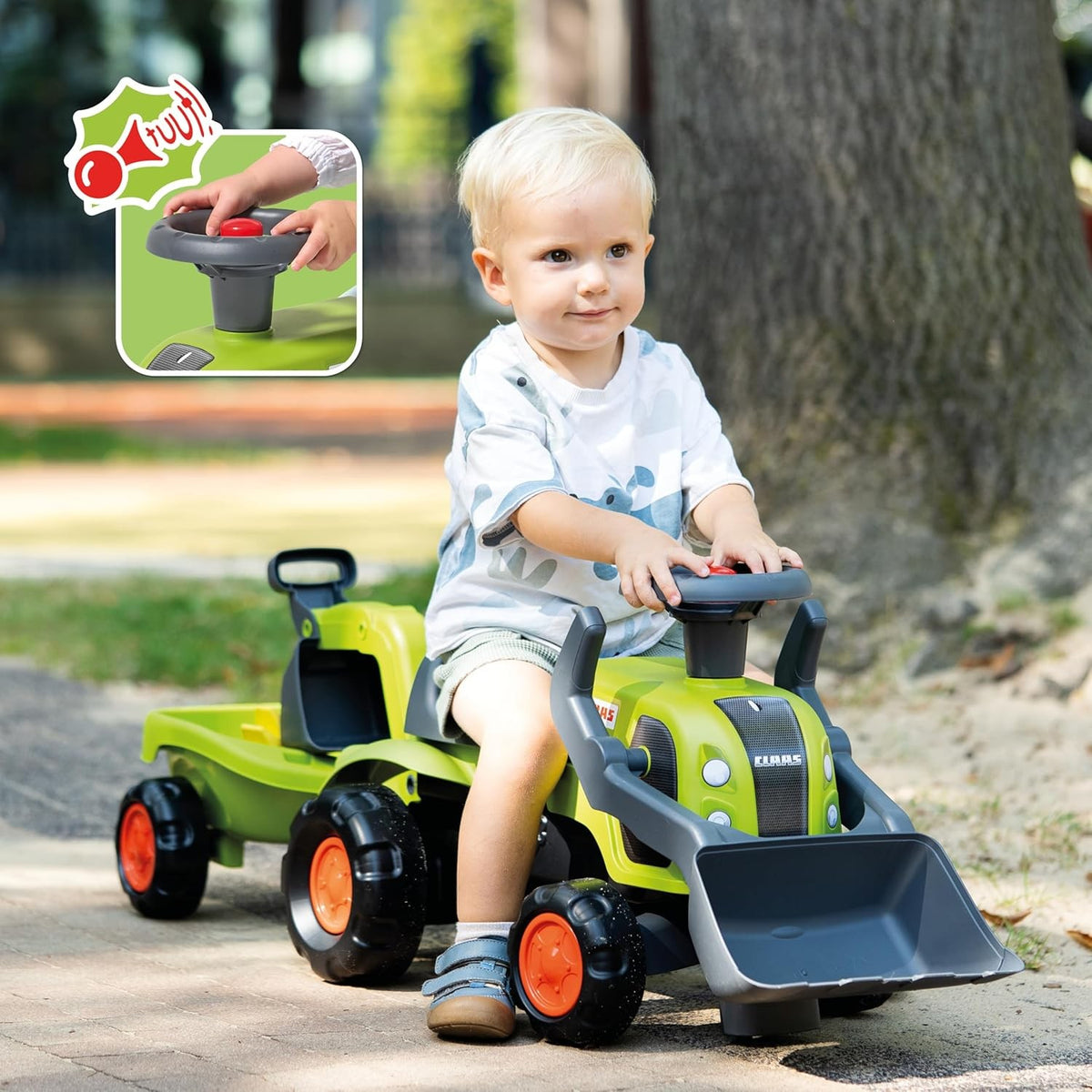 Toddler digging sand with the FALK Claas tractor