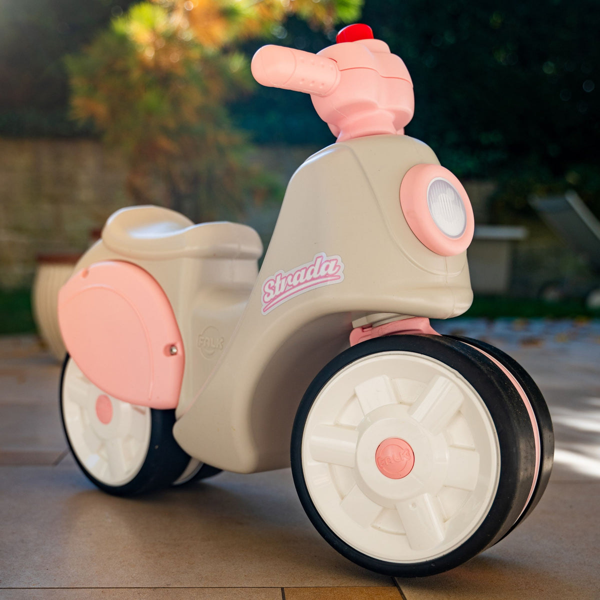 Toddler riding the FALK Strada scooter at home