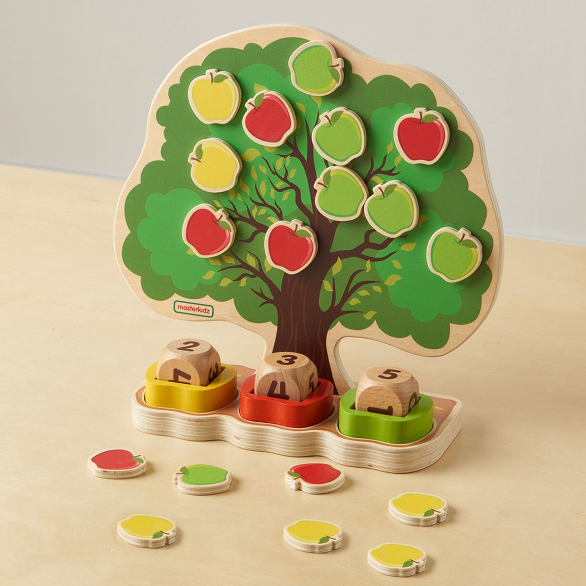 Magnetic apples on the summer side of the wooden tree