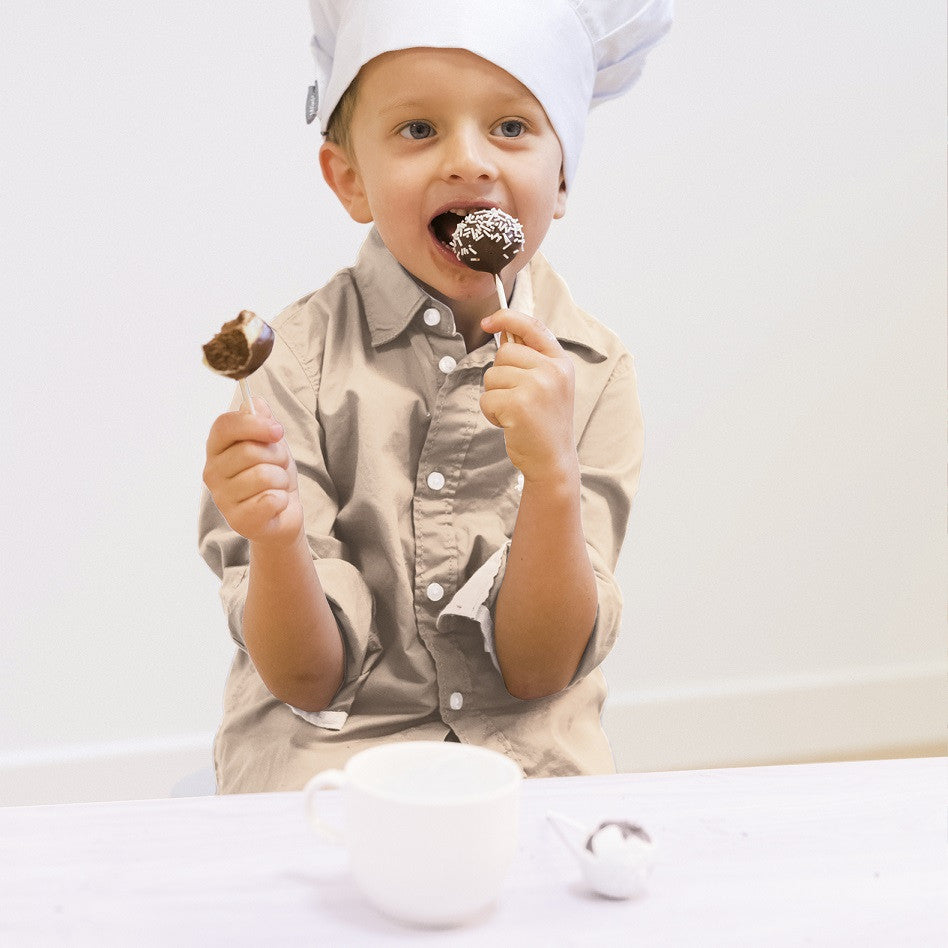 Child decorating homemade cookies with sprinkles