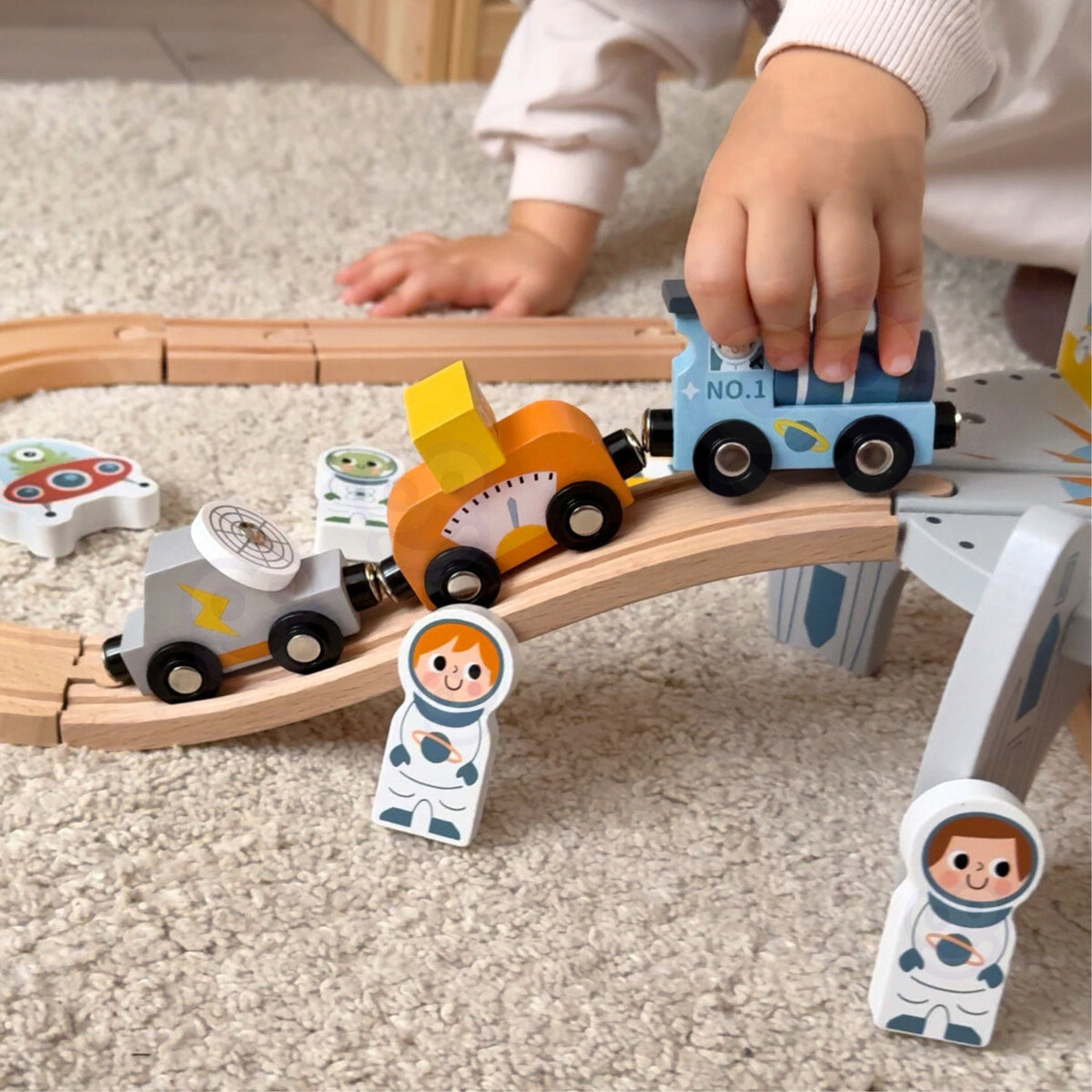 Child driving the space train past the rocket