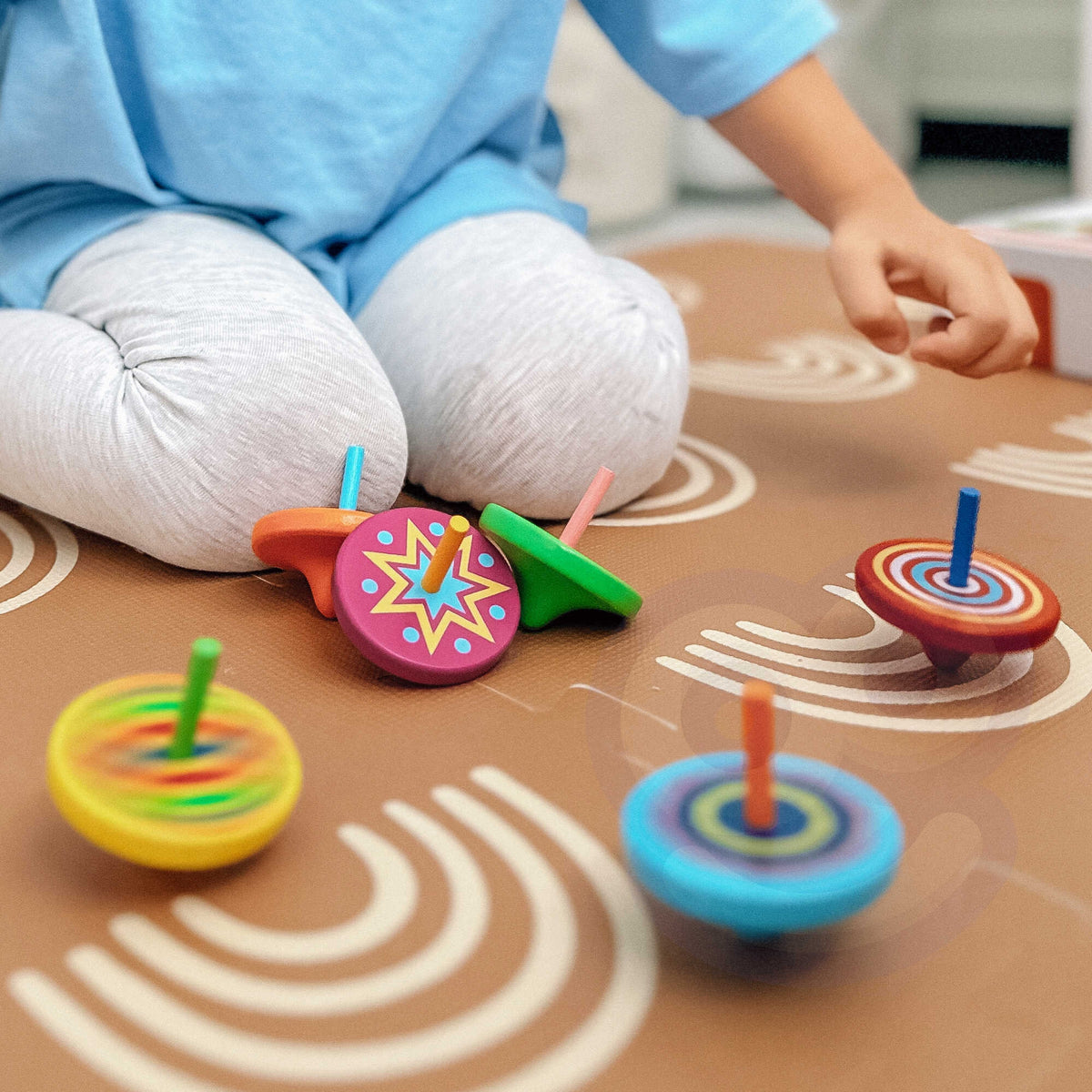 Wooden spinning top creating colourful patterns