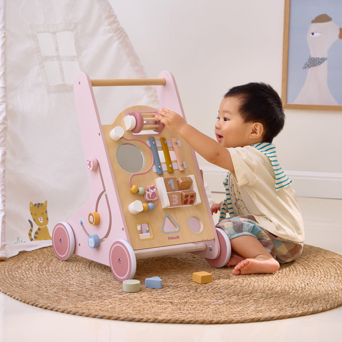 Pastel pink wooden push walker for first steps