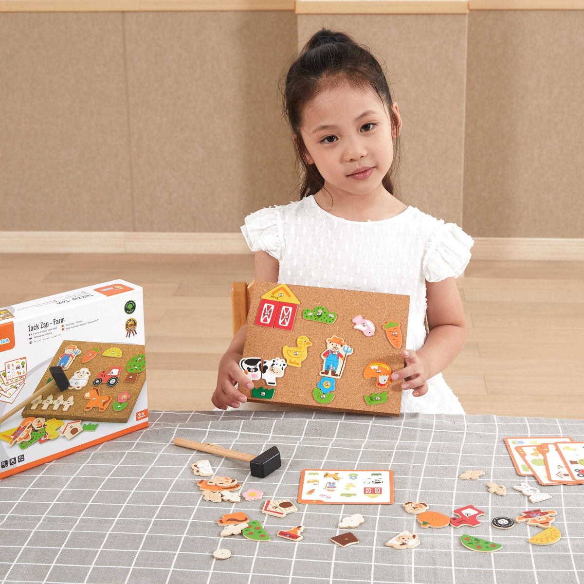 Wooden farm shapes tapped onto the cork board