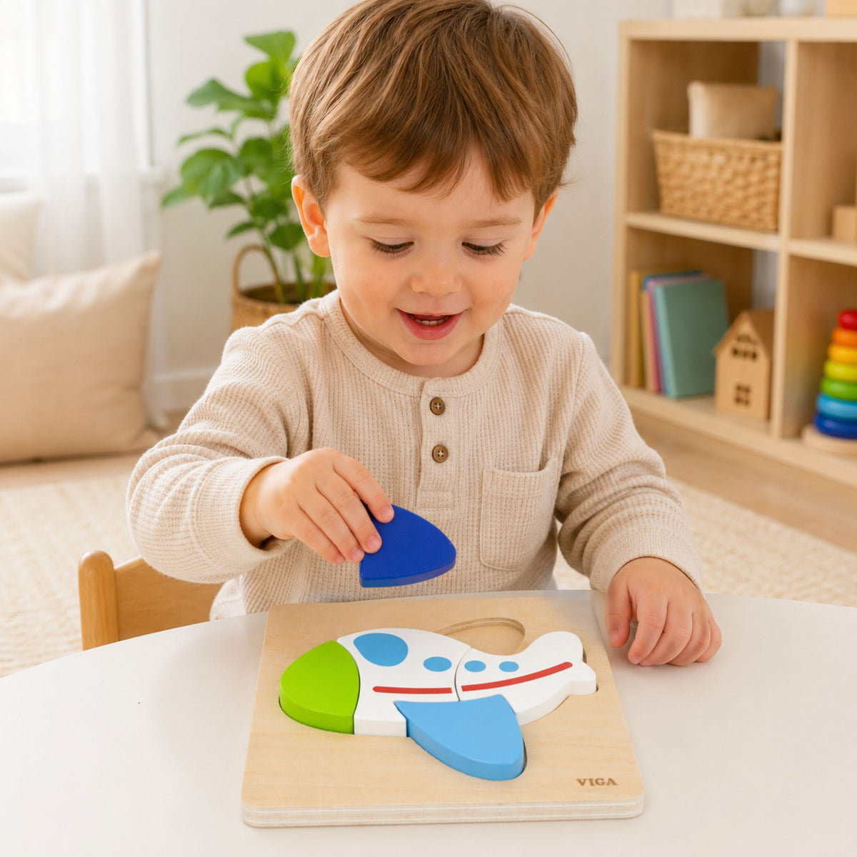 Toddler building the wooden aeroplane puzzle