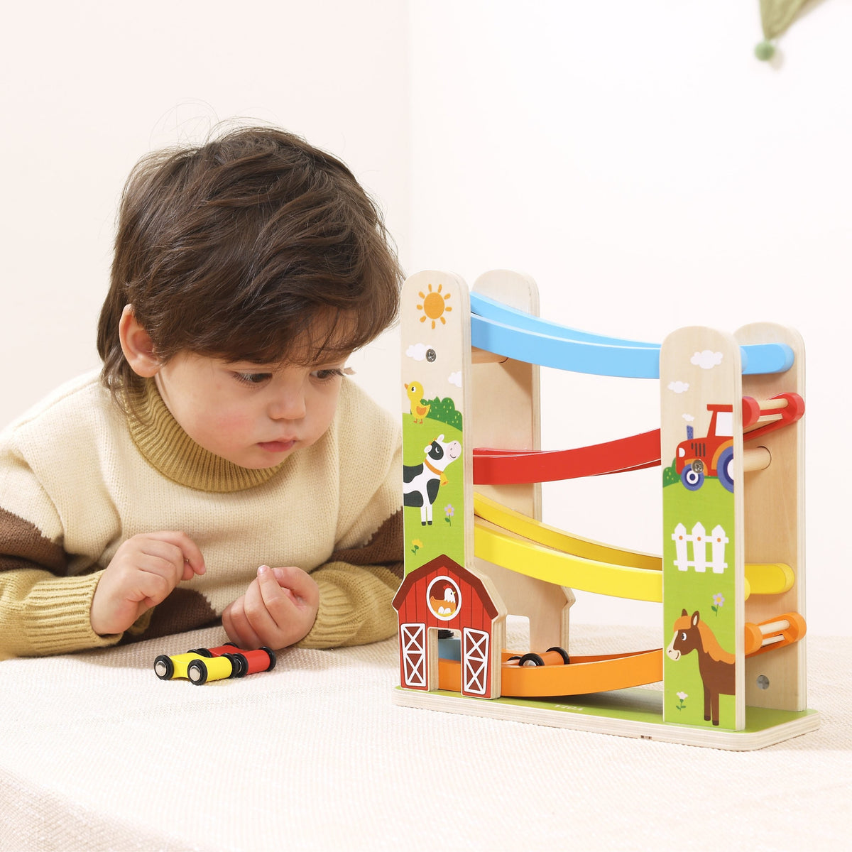 Multi-level wooden ramp with farm animals and barn