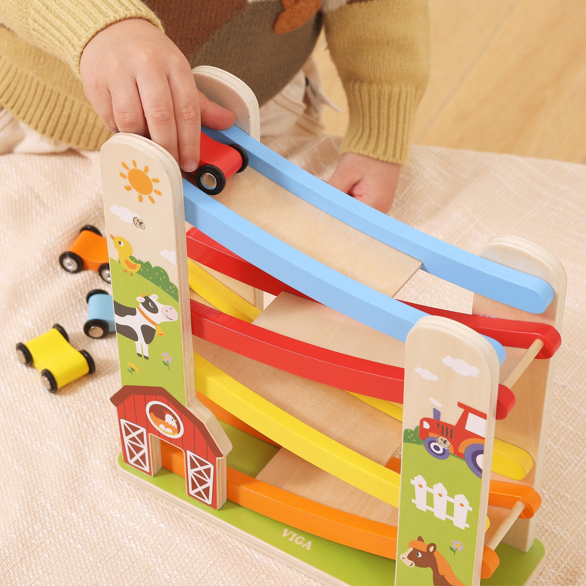 Four colourful wooden cars from the farm ramp