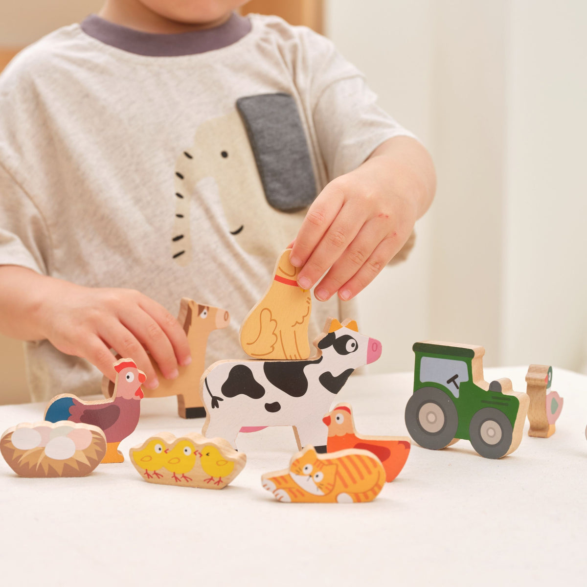 Twelve large wooden farm animal figures for stacking