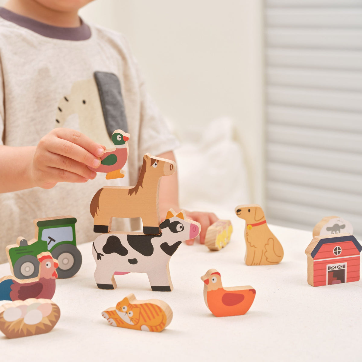 Tower of balanced wooden farm animal figures