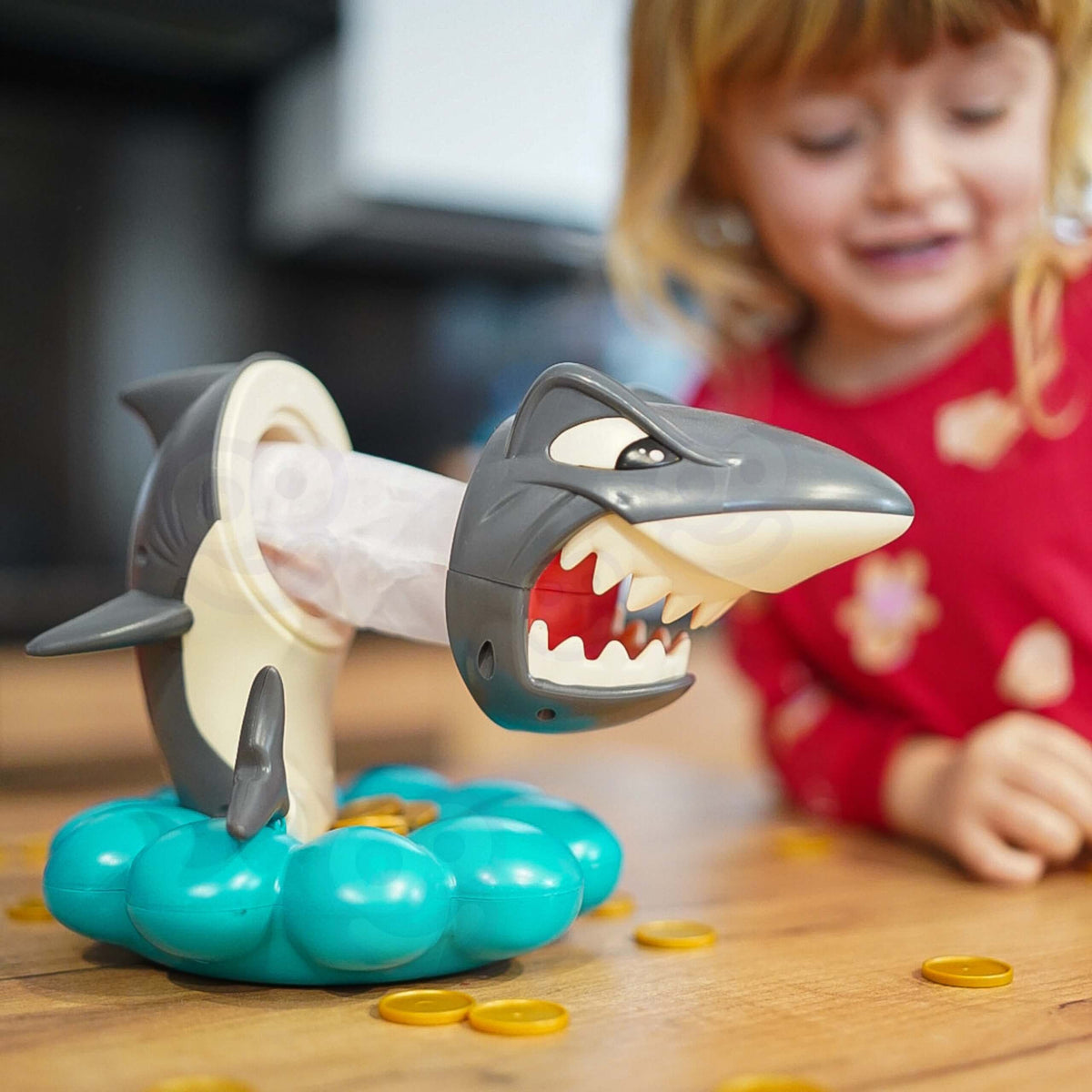 Children grabbing coins before the shark jumps