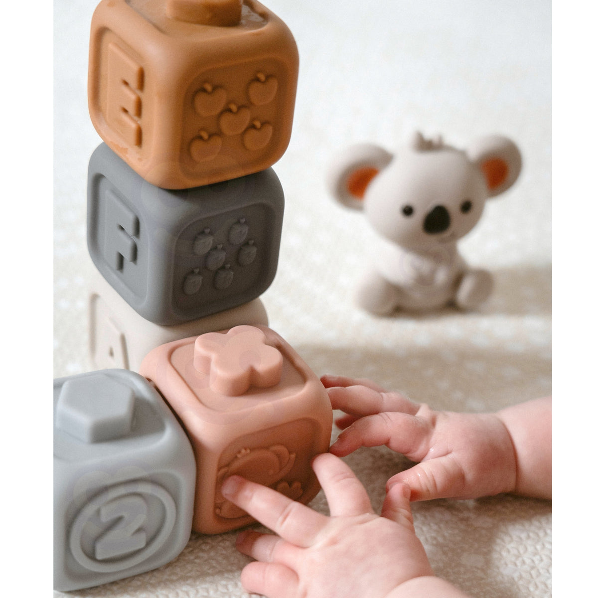Woopie Baby sensory blocks and pyramid – baby chewing a block