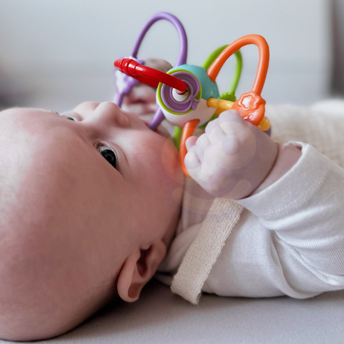 Woopie Baby twisty rattle teether – baby holding rattle
