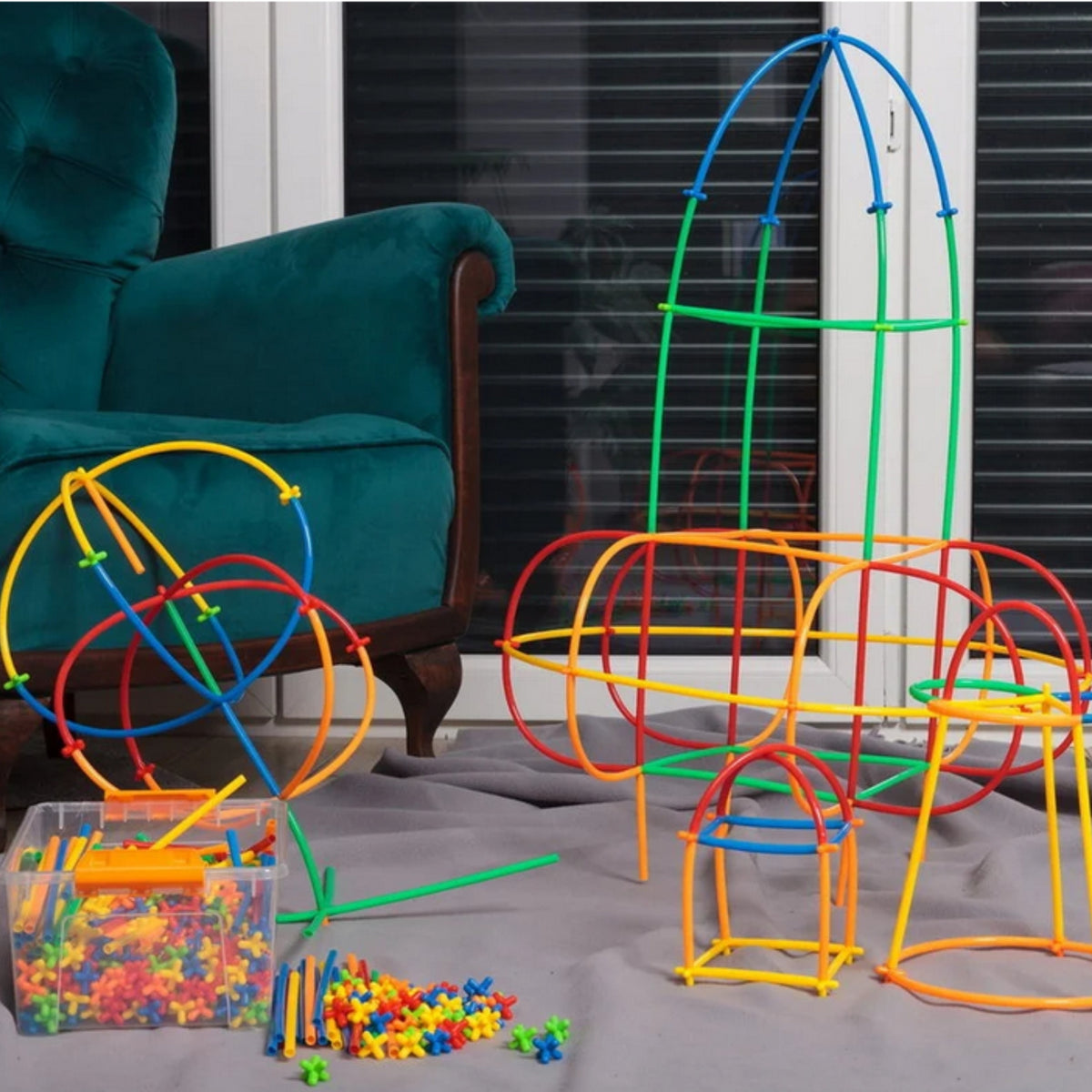 Child joining straws with colourful connectors