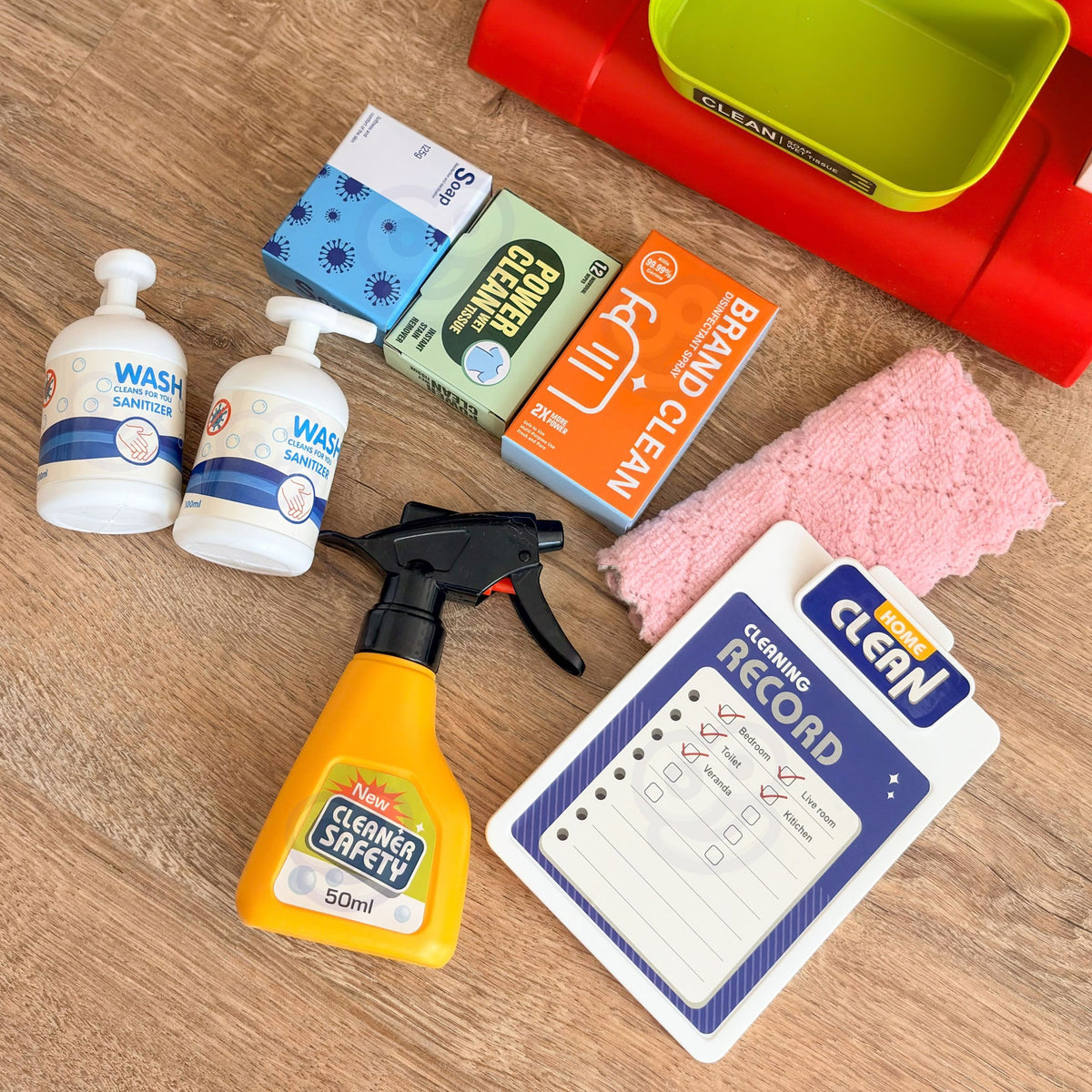 Child sweeping with the toy cleaning cart set