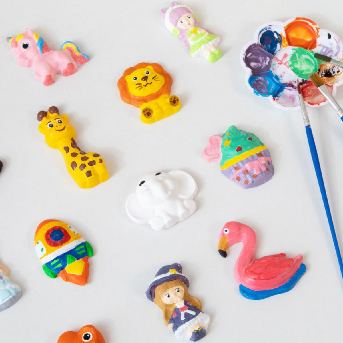 Plaster figures turned into fridge magnets