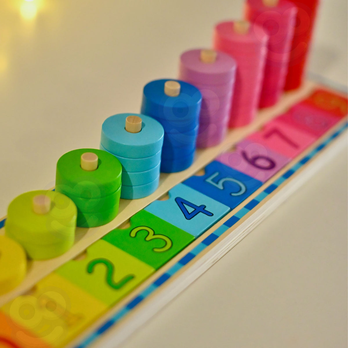 Coloured rings stacked on numbered wooden pegs