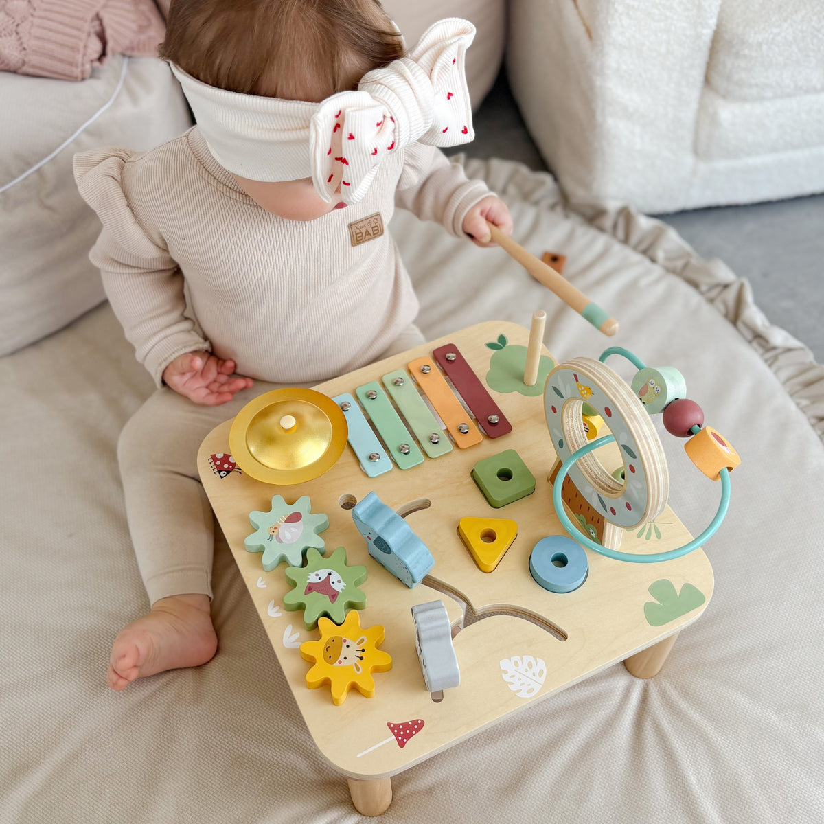 Pastel bead maze on top of the wooden activity table
