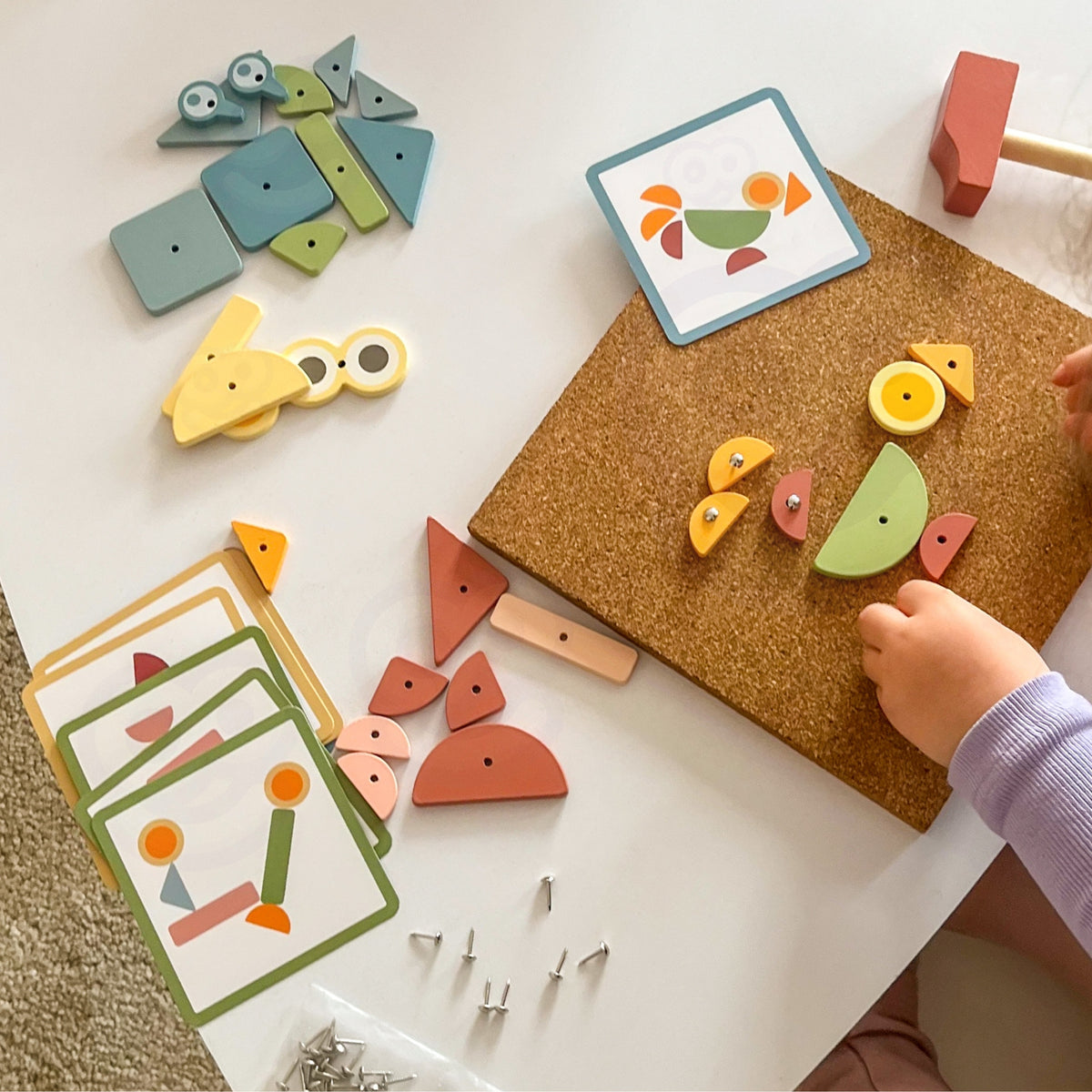Cork board game – tap wooden shapes onto cork with pins