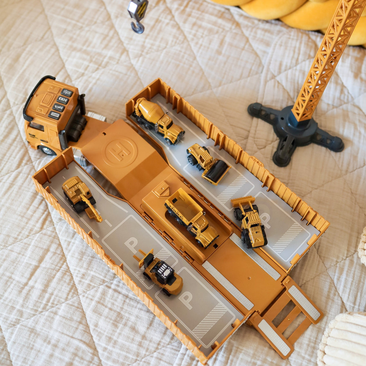 Large toy crane with workers and road cones