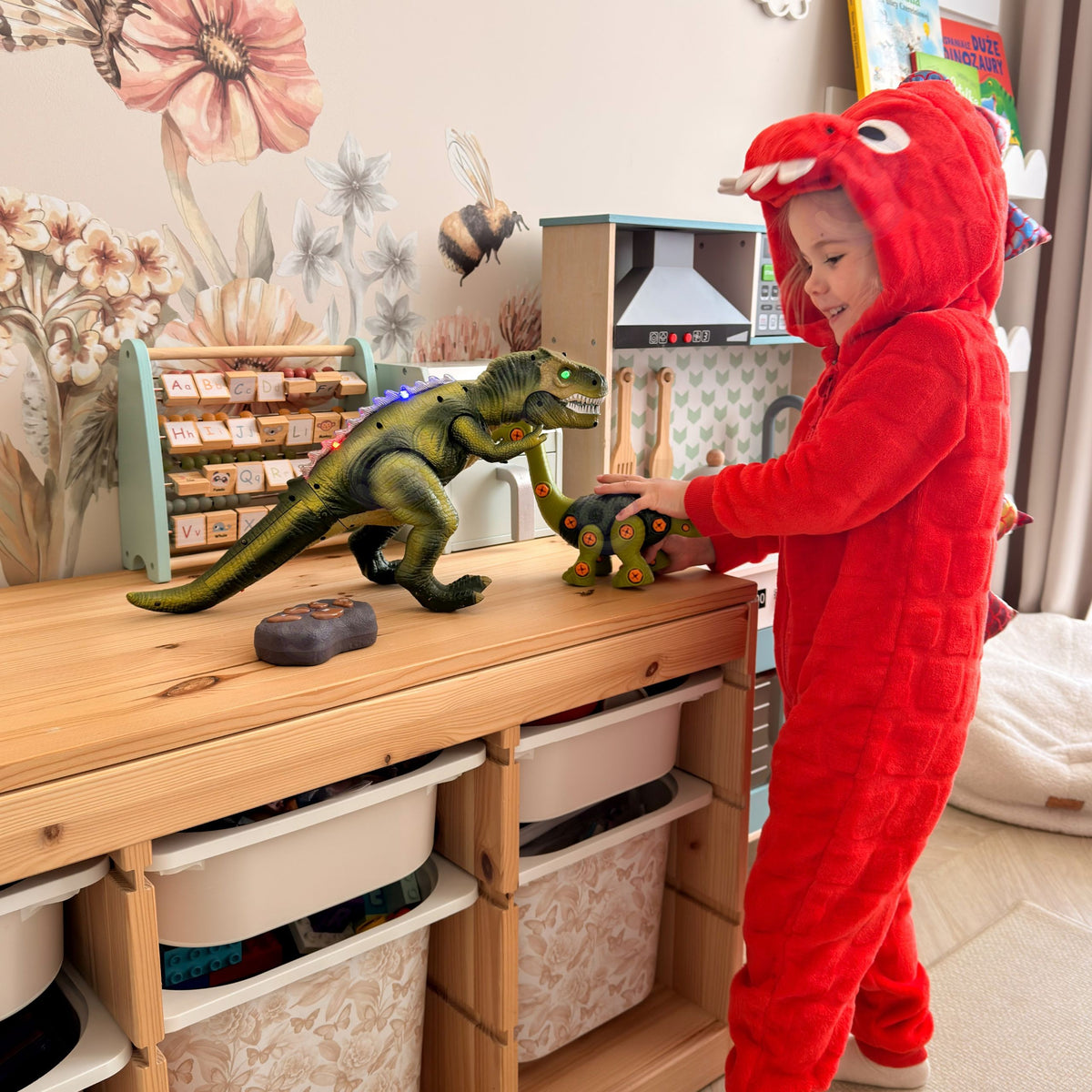 Child steering the RC T-Rex across the floor