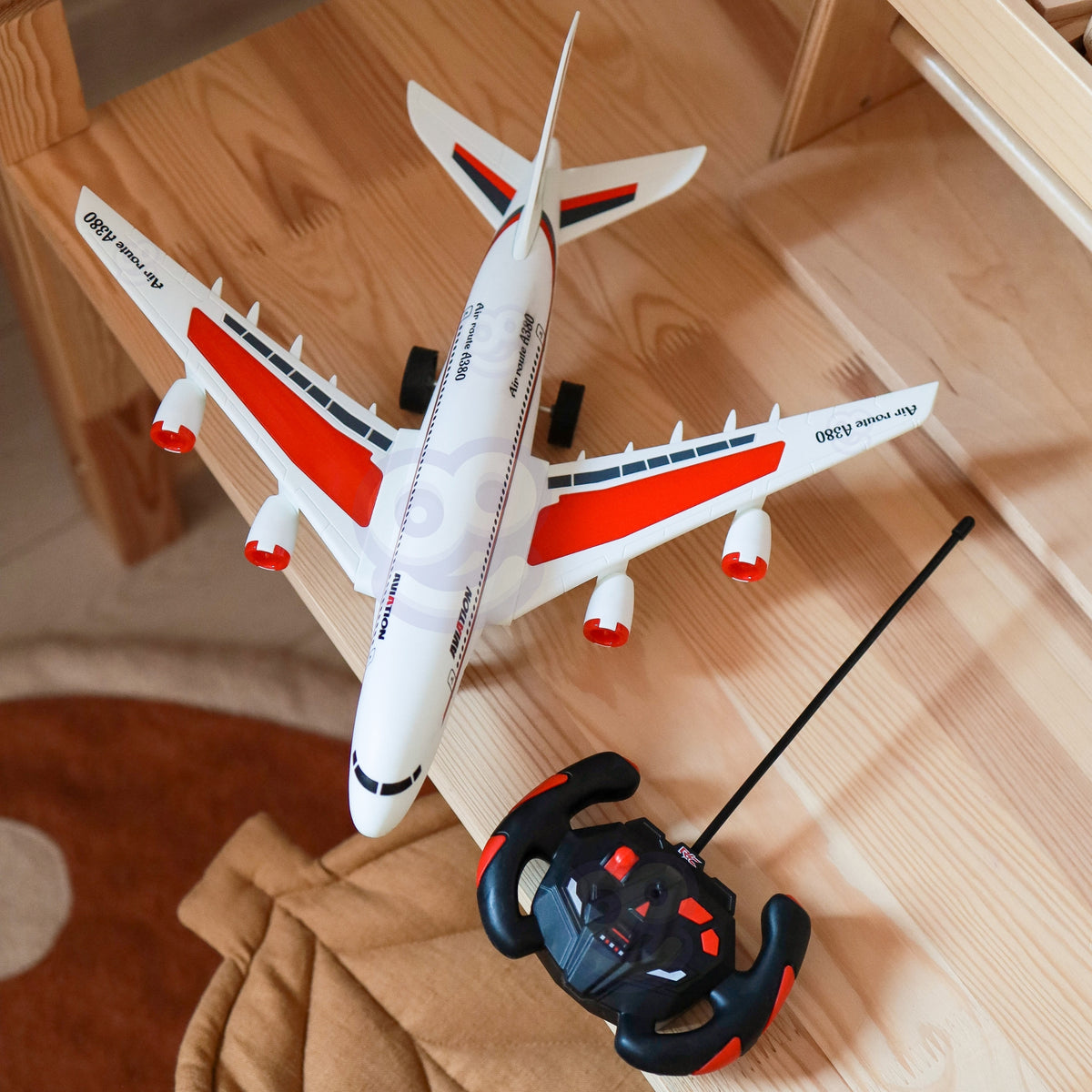 Red and white striped toy airliner from the side