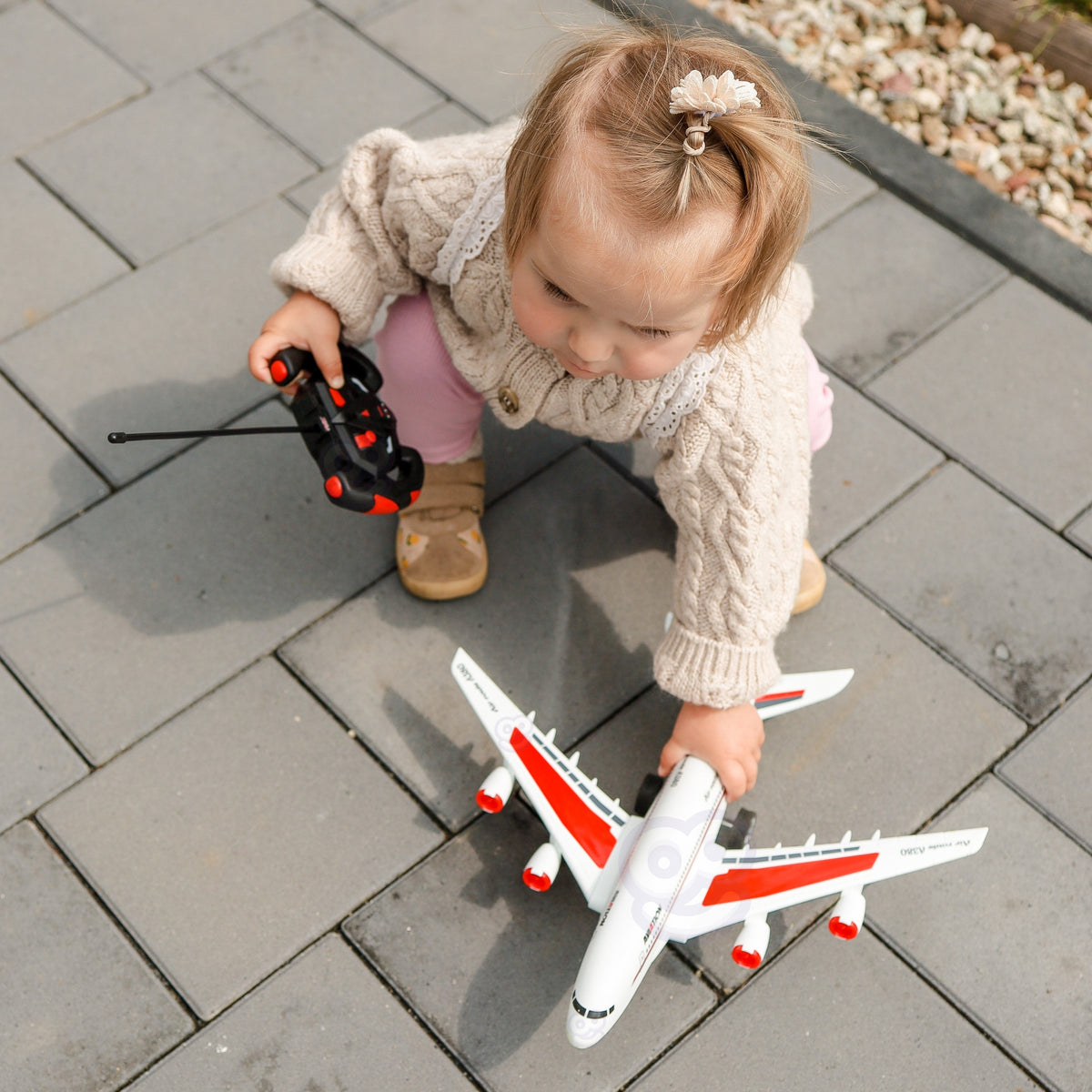 Child steering the plane along a floor runway