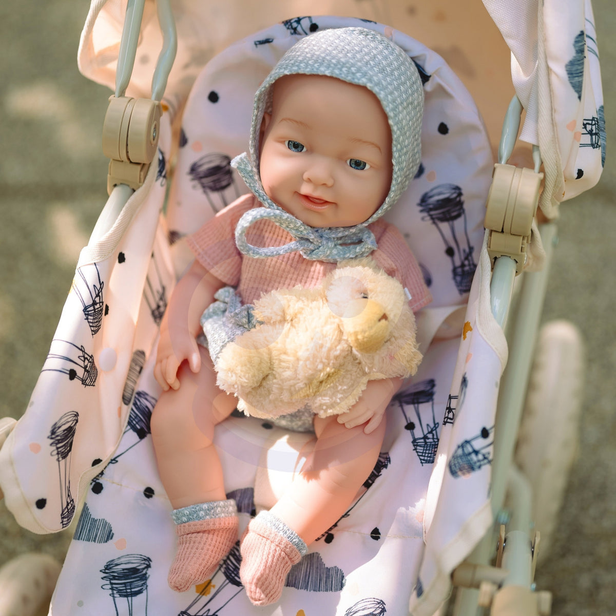 Baby doll in a lovely outfit with matching socks and a hat