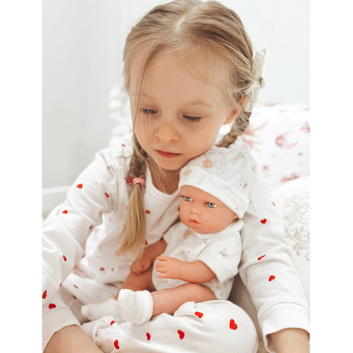 Woopie Royal baby doll with carrier – child carrying the doll on a walk