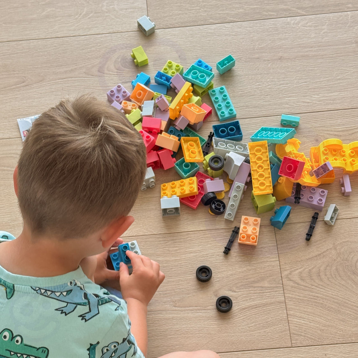 Toy car built from pastel blocks with wheels
